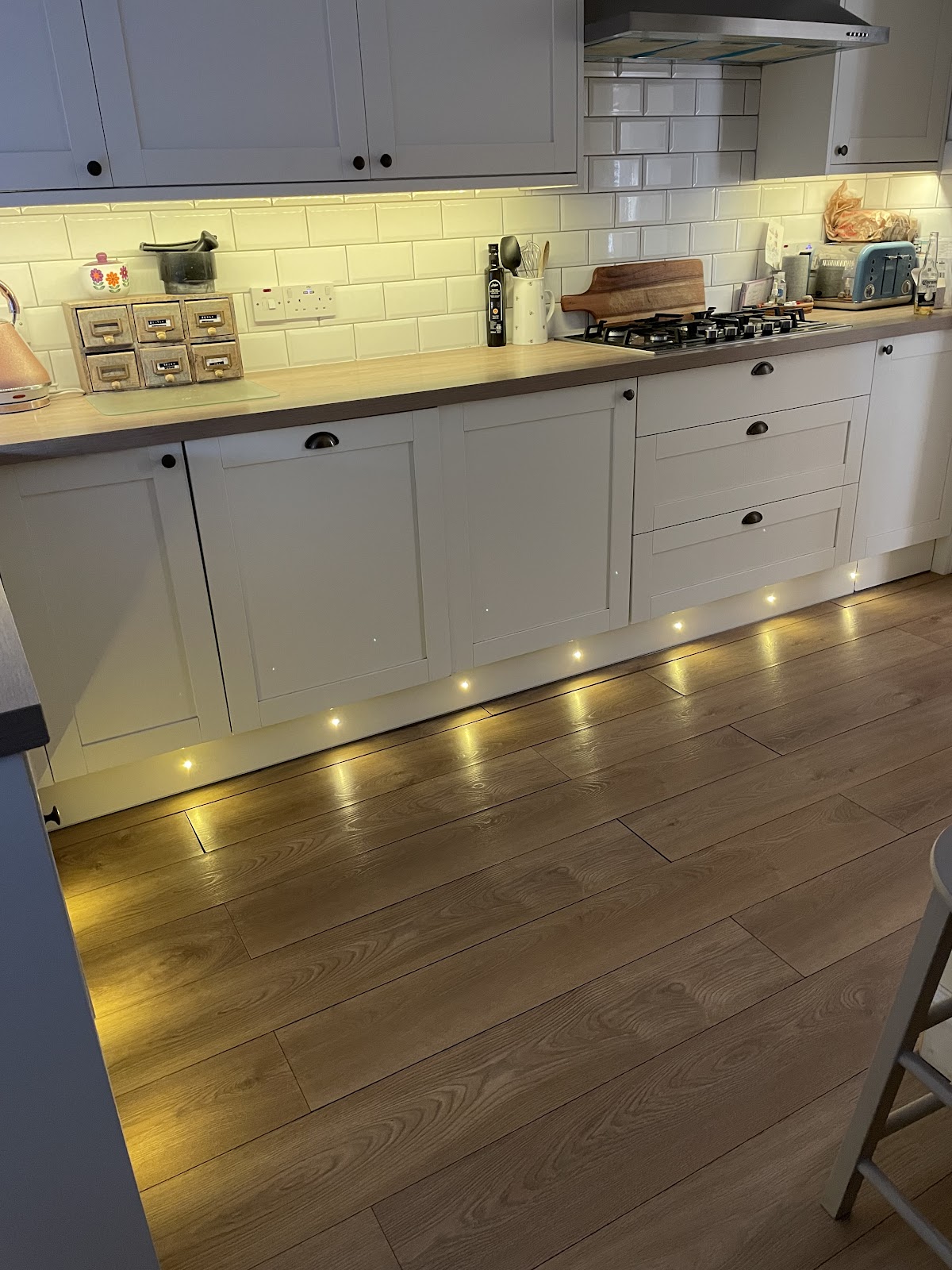 White shaker kitchen with warm LED plinth lighting