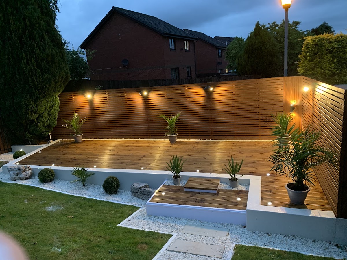 Back garden at dusk with deck lights, step lights and fence downlighters