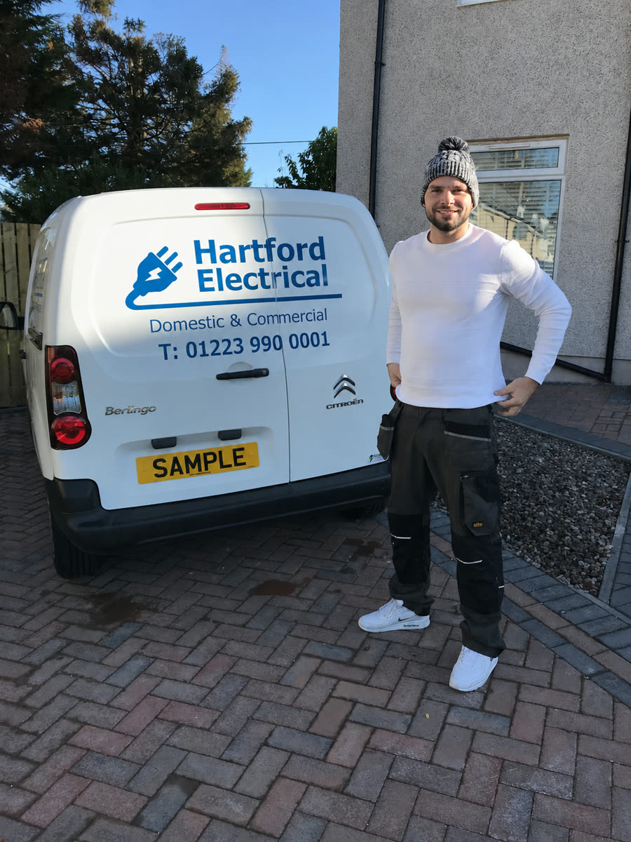 James, the electrician behind Hartford Electrical, beside the company van